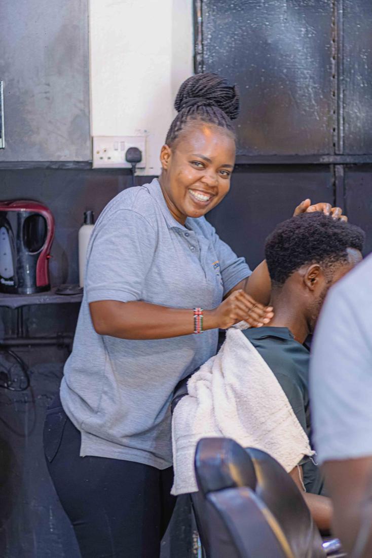 A team member smiling during a hair treatment