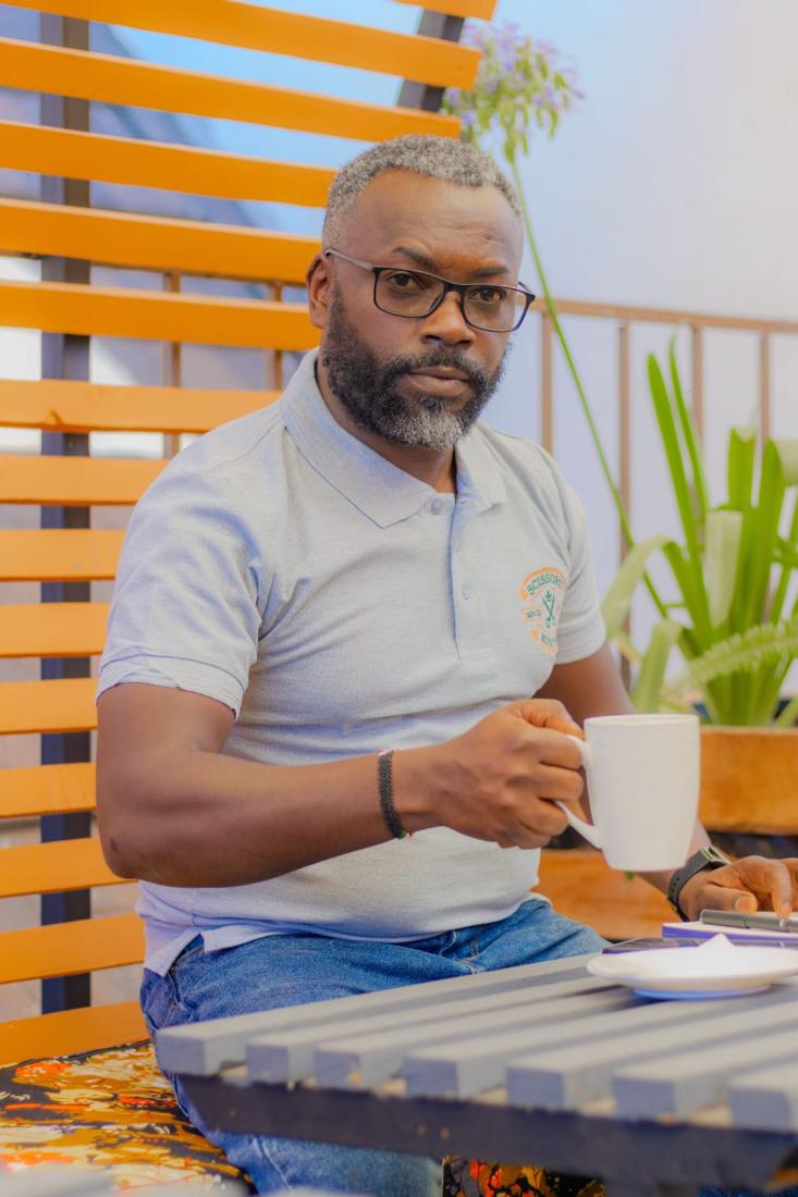One of the Scissors Kinyozi team, relaxed at a table